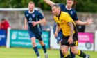 Wayne Mackintosh, in yellow, has extended his stay with Nairn County