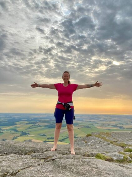 Nicola at the peak of Bennachie in Aberdeenshire, which sparked her wellness coaching business.