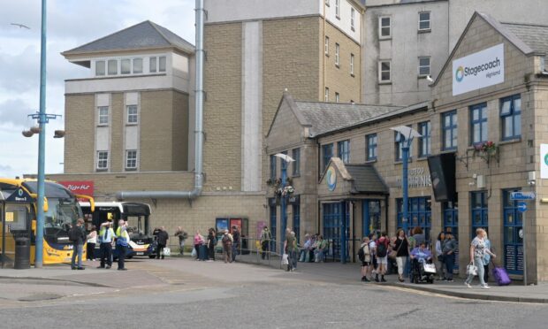Crowds stand outside Inverness Bus Station as they wait for their bus connection.