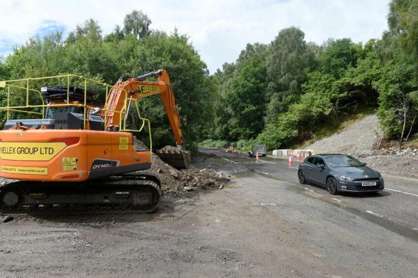 A yellow digger was used to help clear away the debris from the road.