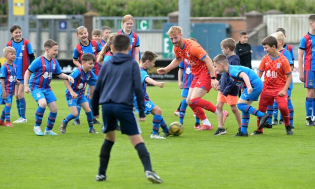 Caley Thistle star David Carson finds the midfield busier than ever in this match with a difference. Images: Sandy McCook/DC Thomson