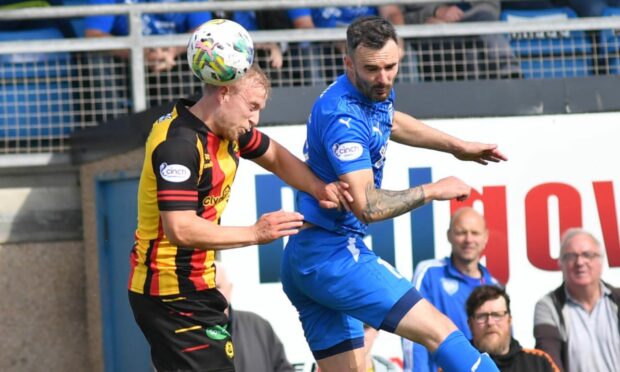 Peterhead's Scott Ross and Partick Thistle's Ben Stanway battle for a header in the Viaplay Cup.