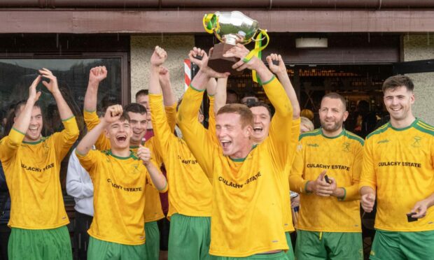 Glengarry team captain Nick Dalgety lifts the Single Team Cup trophy.  Image: Neil Paterson.