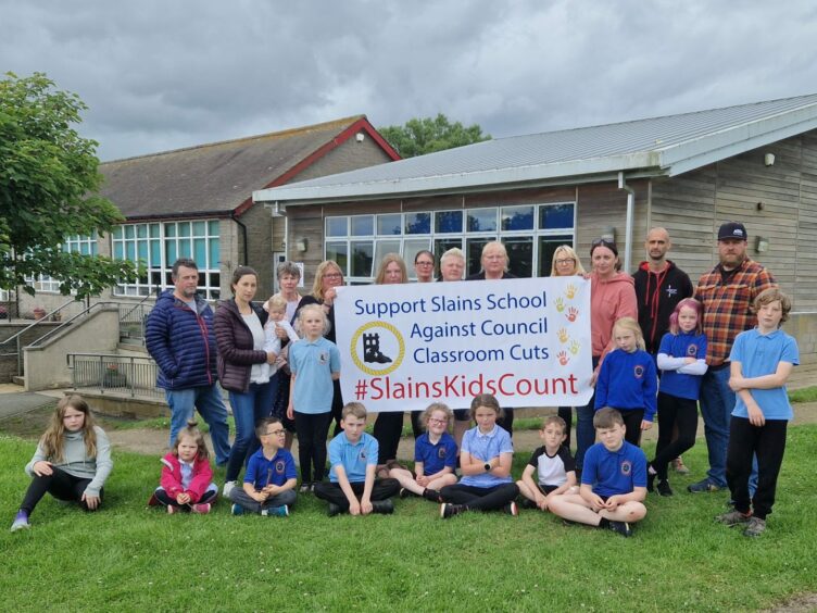 Slains School pupils and parents protesting against Aberdeenshire council with sign that reads: 'Support Slains School Against Council Classroom Cuts'