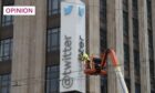 A worker removes the letters from outside Twitter HQ in San Francisco - without the proper permission (Image: John G Mabanglo/EPA-EFE/Shutterstock)