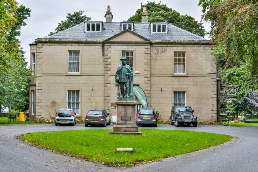 An exterior shot of Nairn Museum with a statue outside