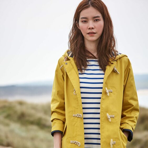 A model in a Seasalt Cornwall jacket and dress