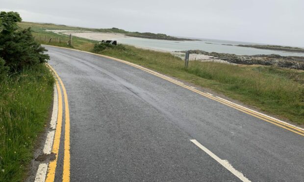 B8008 coastal road with double yellow lines.