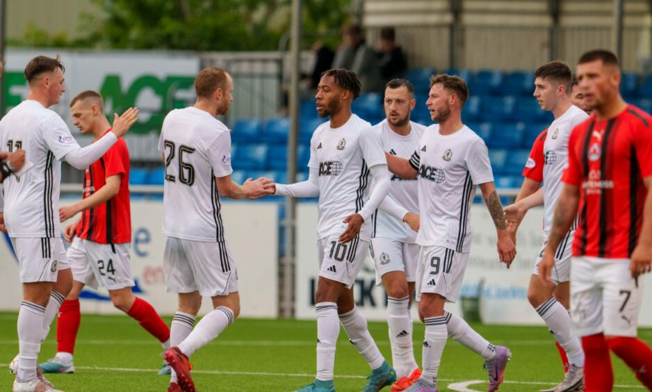 Cove Rangers celebrate with Rumarn Burrell after his goal against Clyde in the Viaplay Cup.