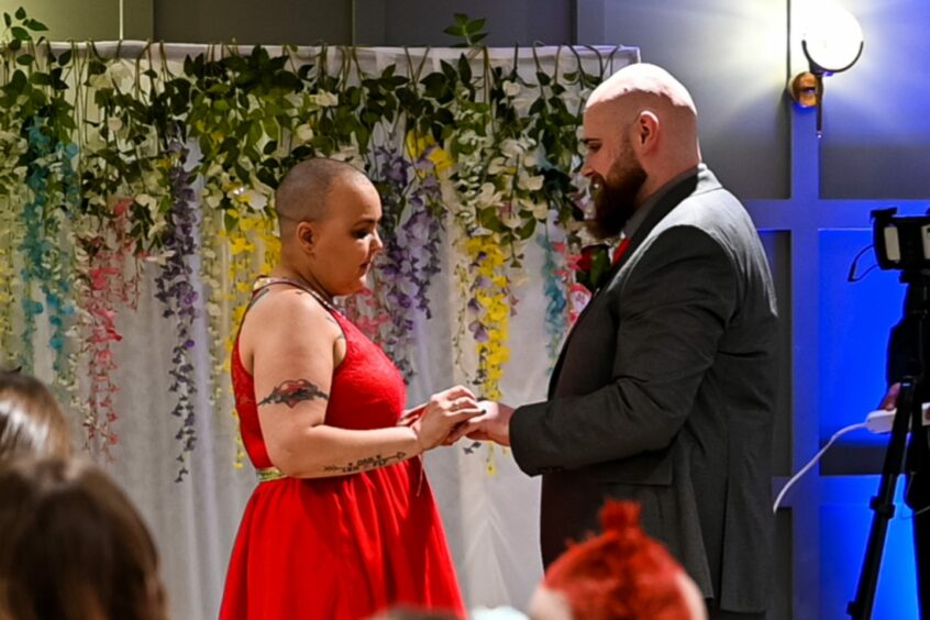 Amanda and Dan exchanging vows at their wedding.
