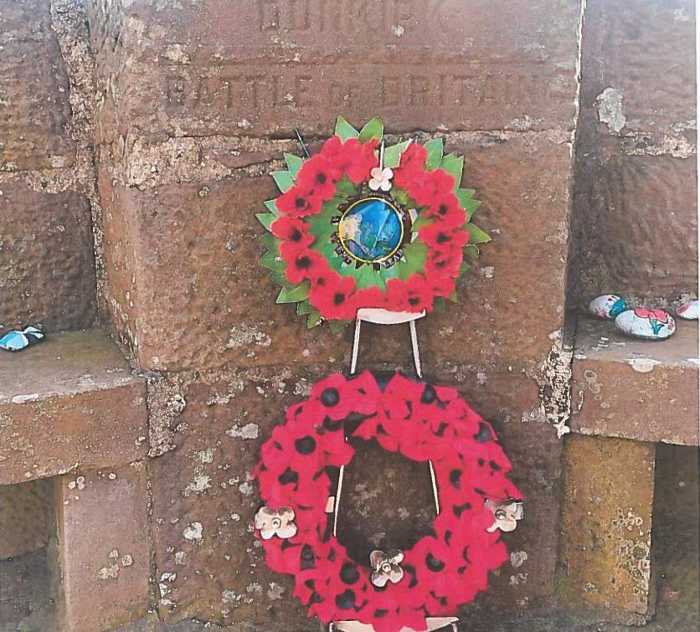 Wreaths on a bracket at the stone monument