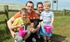 From left, Thomas Nicolson, with dad Craig, mum Sarah and brother Ben enjoying a day at Doonies Farm. Image: DC Thomson