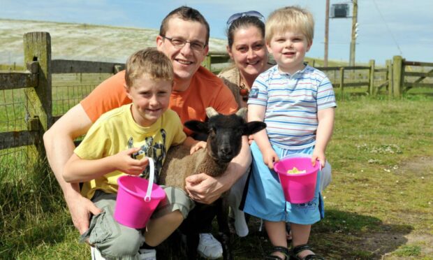 From left, Thomas Nicolson, with dad Craig, mum Sarah and brother Ben enjoying a day at Doonies Farm. Image: DC Thomson