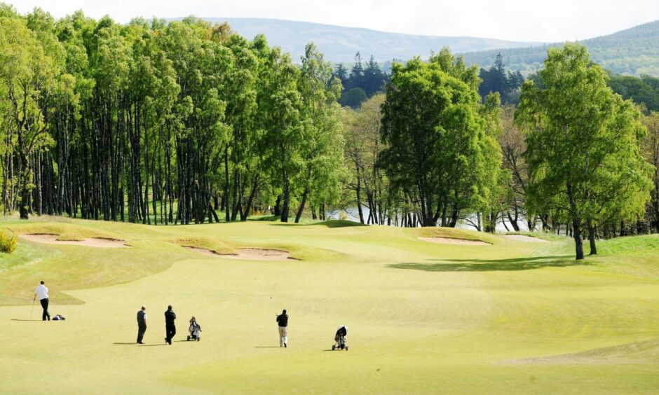 Golfers at a golf course in the Highlands.
