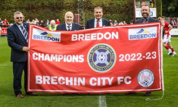 Picture shows from left to right; John Campbell, Highland League secretary, Sandy Sinclair, senior vice president, Kevin Mackie, Brechin City chairman and Alan Morrison from Breedon with the championship flag.  Image: Mhairi Edwards/DC Thomson