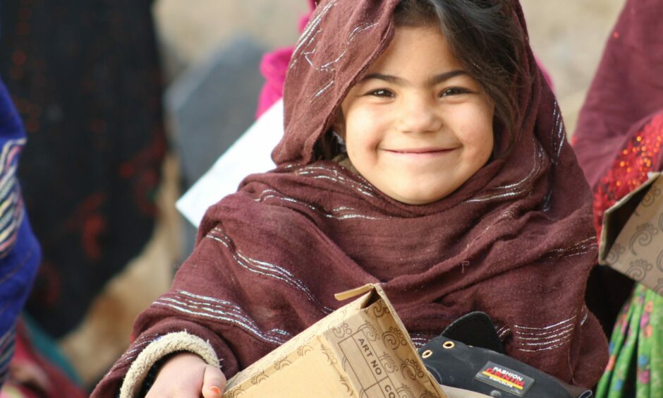 A young Afghan girl with winter shoes donated by The Linda Norgrove Foundation.