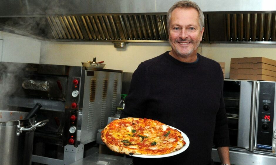 Nick Nairn holding a pizza at Nick's Pizza bar and Cafe before he shut the business.
