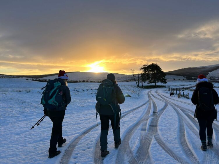 Gillian walking through a snowy terrain with Usana Mindset clients.