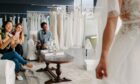 Bride showing her friends the wedding dress she's chosen.