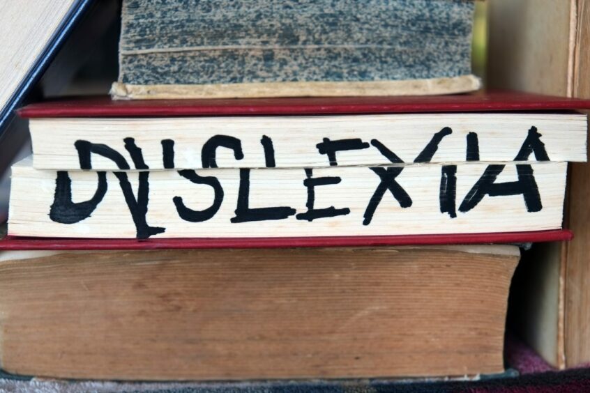 Book spelling out dyslexia in broken lettering on its side.