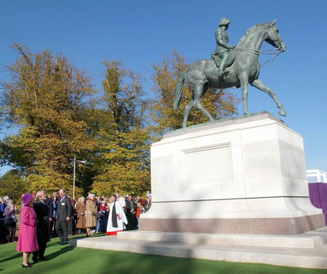 Queen Elizabeth with Philip, inspecting the statue in Windsor Great Park upon its unveiling in 2003.