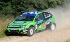 Bruce McCombie and co-driver Michael Coutts in action in their lime green Ford Focus at the 2022 Grampian Forrest Rally