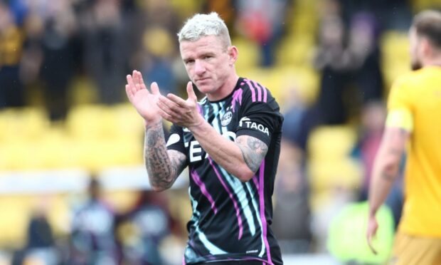 Jonny Hayes clapping his hands on the pitch