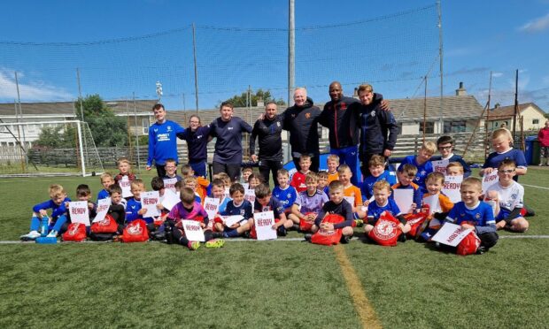 At the back of this group with the kids ages from six to nine are, from left: Dylan Davidson, Rachael Prideuex and Liam Mackinnon, who are young leaders from High Life Highland, beside Rangers coach Allan Milne, Alex McLeish, Marvin Andrews and Rangers coach Connor Wright. Images: Alyn Gunn/Thurso Football Academy