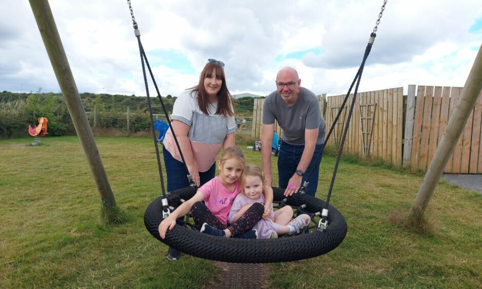 Karen and Euan Sutherland with their two daughters Jessie and Elsie on the giant swing