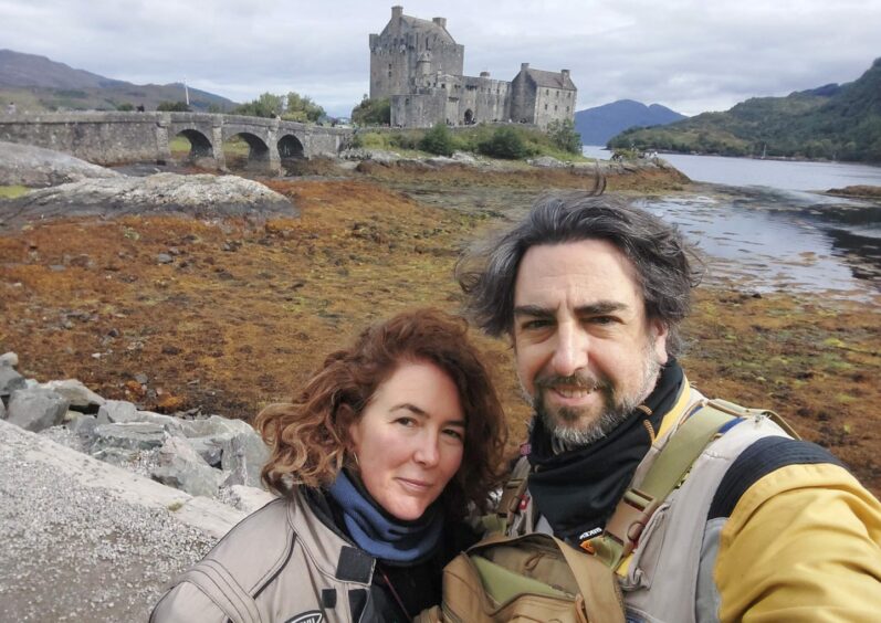 Juan Antonio Espeso González and his wife Angela outside Eileen Donan Castle on a road trip to Skye to find buried treasure.