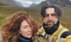 Juan Antonio Espeso González and his wife Angela in front of large hills on Skye where they are looking for buried treasure.