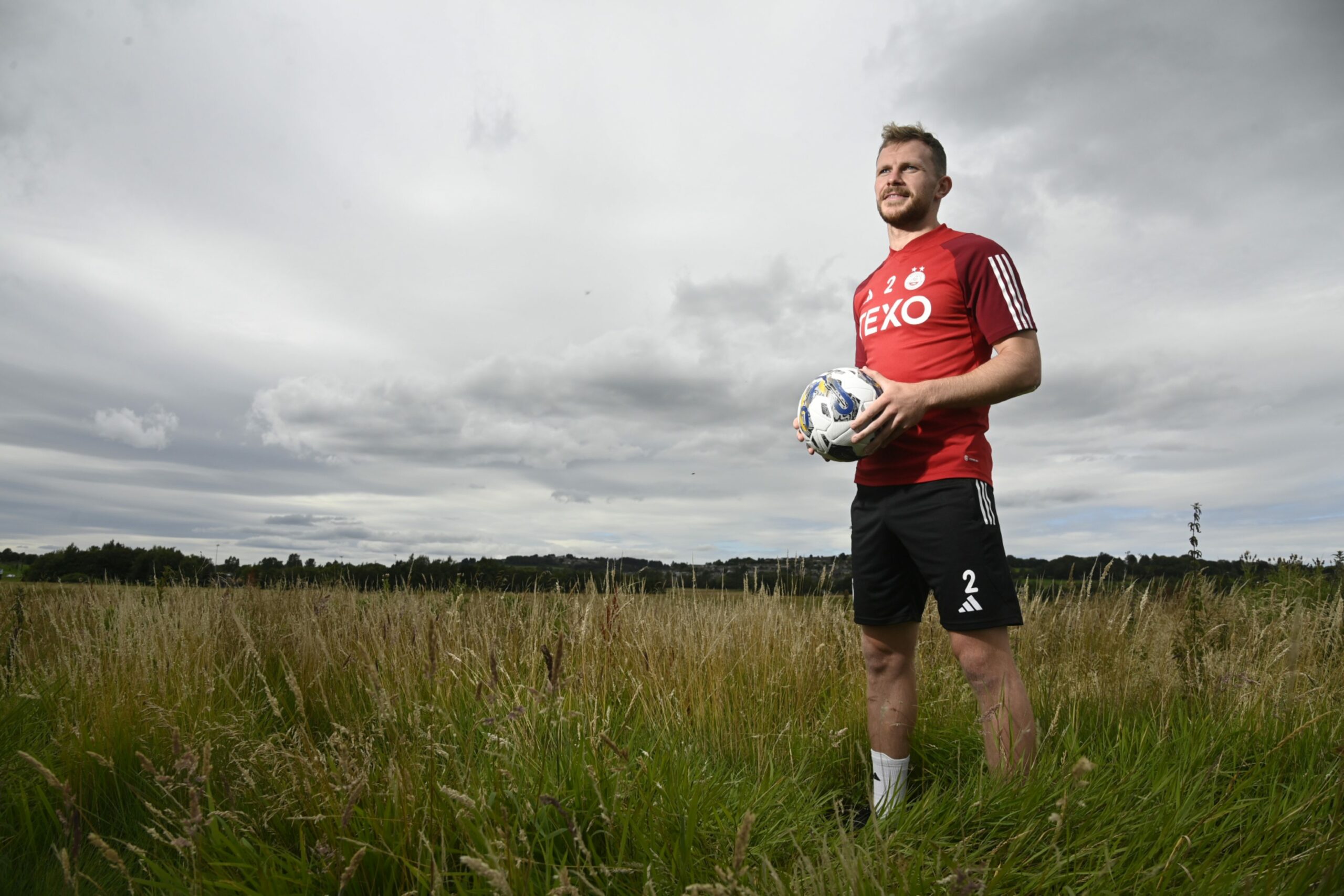Aberdeen defender Nicky Devlin pictured beside the club's Cormack Park training complex. Image: SNS 