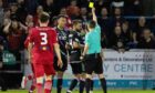 Aberdeen's Bojan Miovski is shown a yellow card from referee David Munro. Image: SNS.