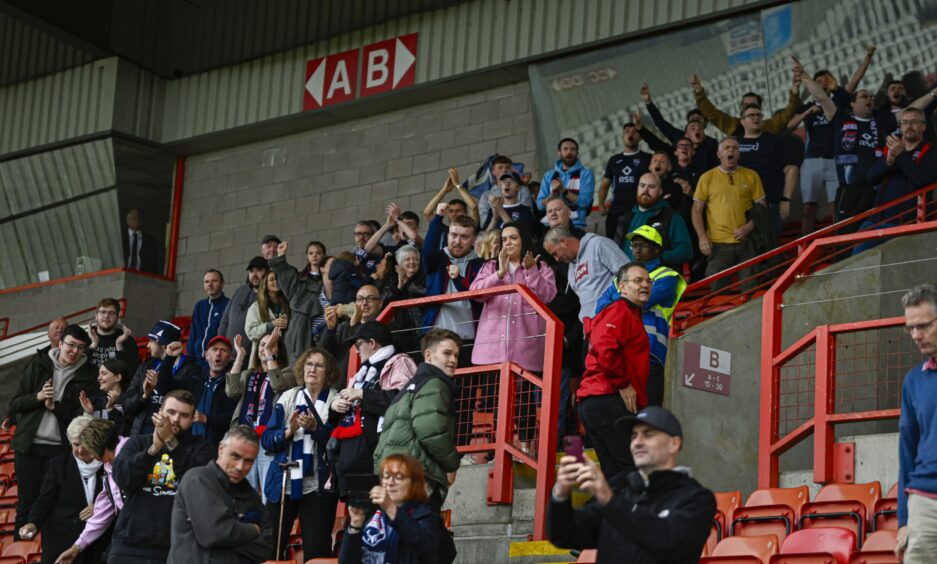 The Ross County fans celebrate League Cup win
