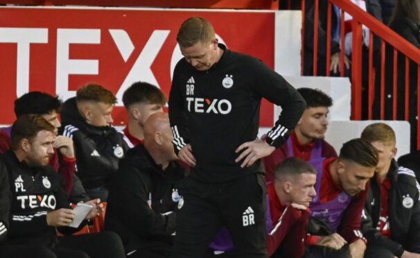 Dons boss Barry Robson looks dejected after BK Hacken's Ibrahim Sadiq made it 1-0 at Pittodrie. Image: SNS