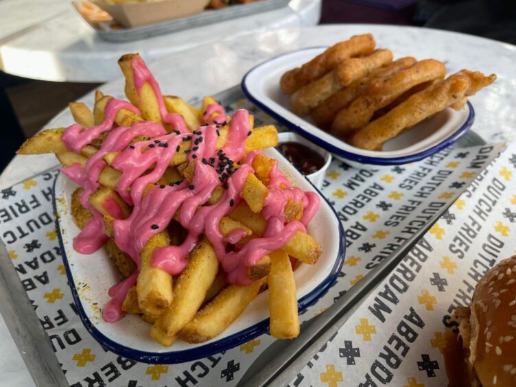 Fries with pink mayo and a dish on onion rings