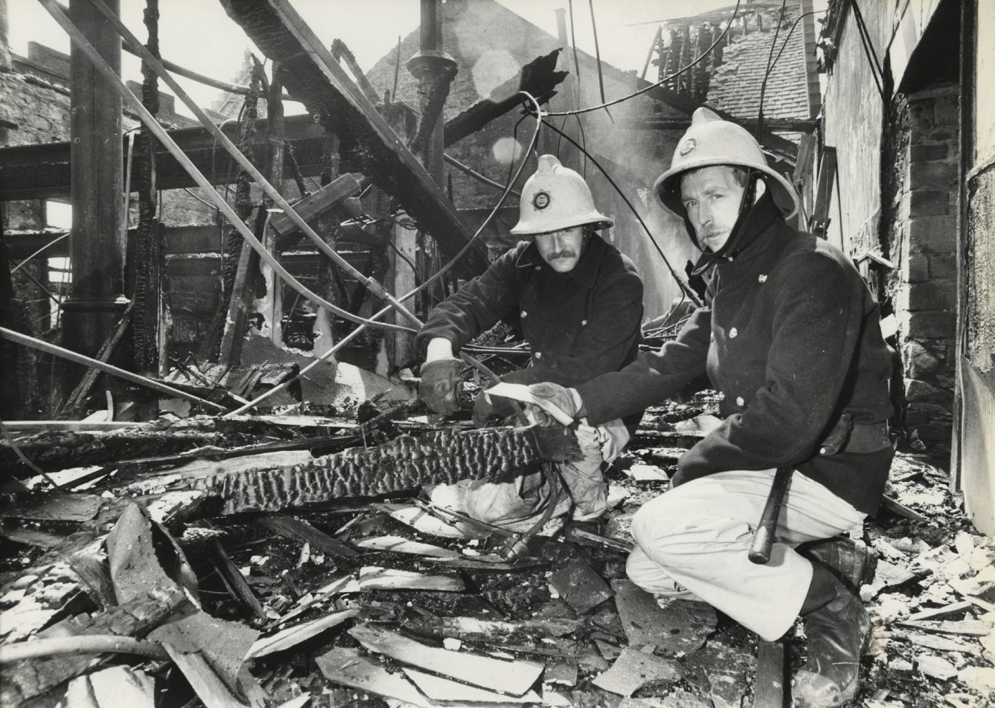 Two firemen, both former pupils of Aberdeen Grammar, in the burned out shell of the library in 1986.
