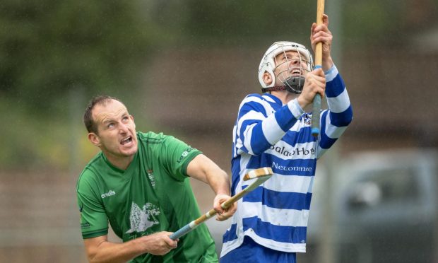 Newtonmore's Rory Kennedy (right) and David MacLean (Beauly) wait for a high ball. Image: Neil Paterson.