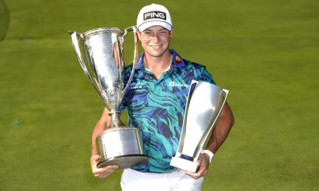 Viktor Hovland holds the Western Gol Association trophy, left, and the BMW Championship trophy after winning in the final round of the BMW Championship on Sunday. Image: PA.
