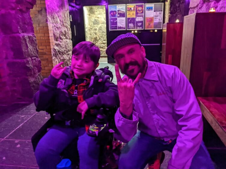 Hard rock fan Baxter with Baz Mills of Massive Wagons, when he was guest of honour at their show in Aberdeen last year.