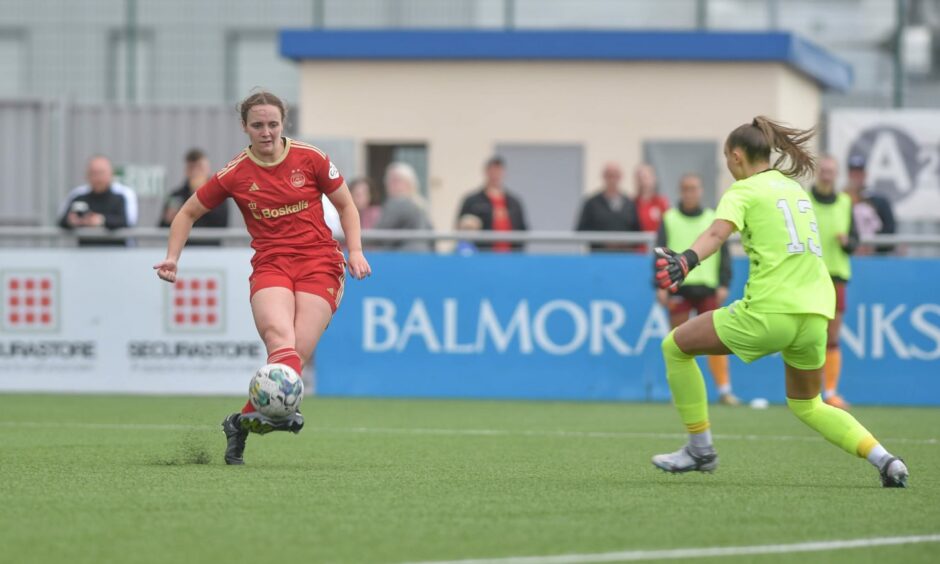 Aberdeen Women's Bayley Hutchison in action against Motherwell goalkeeper
