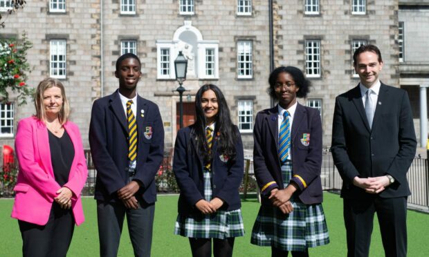 Head of senior school Clare Smith (left) and head of school Robin Macpherson (right) celebrate this year's exam results with Robert Gordon's College pupils Owen Izedonmwen (S4), Jefline Jacob (S5) and Oyenmwen Izedonmwen (S6). Image: Robert Gordon's College