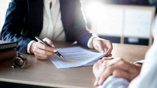 An advisor taking someone through a financial document.