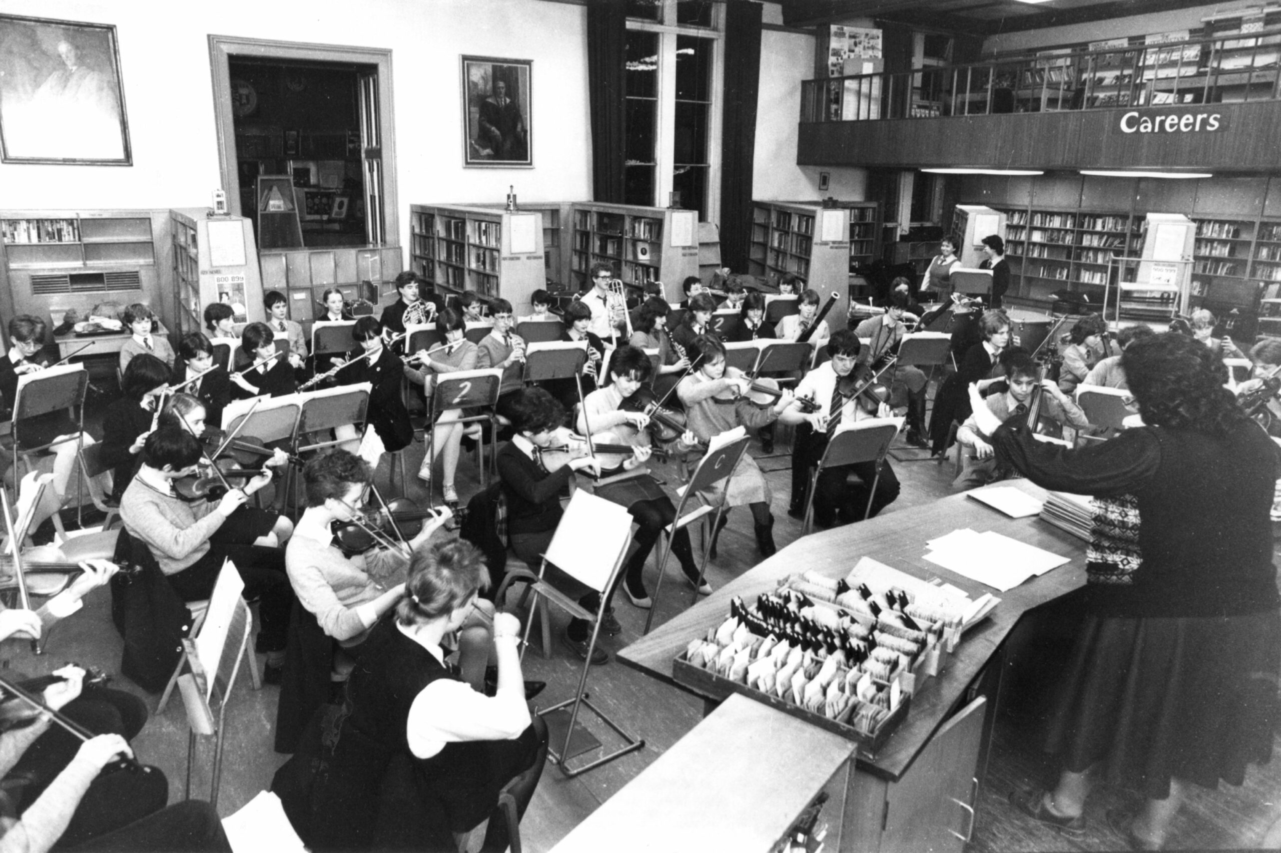 Aberdeen Grammar School orchestra takes over the library at the school for Christmas rehearsals as head music teacher Anne Brown wields the baton in 1983.