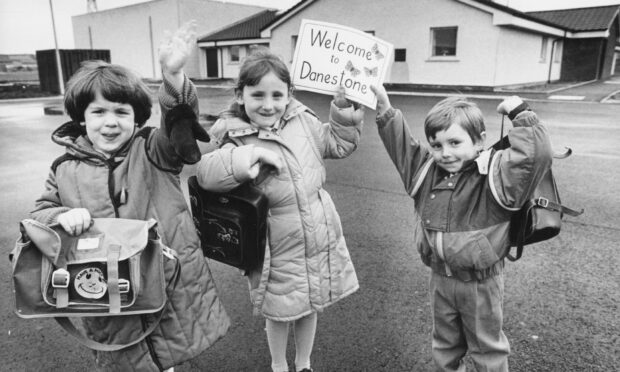 A big welcome for all their Primary One school friends from the first three pupils at the new Danestone Primary School, Bridge of Don, which opened its doors in 1986. From left, Hannah Hesp, Lynsey Anderson, and Andrew Pirie, show off their special welcoming sign.