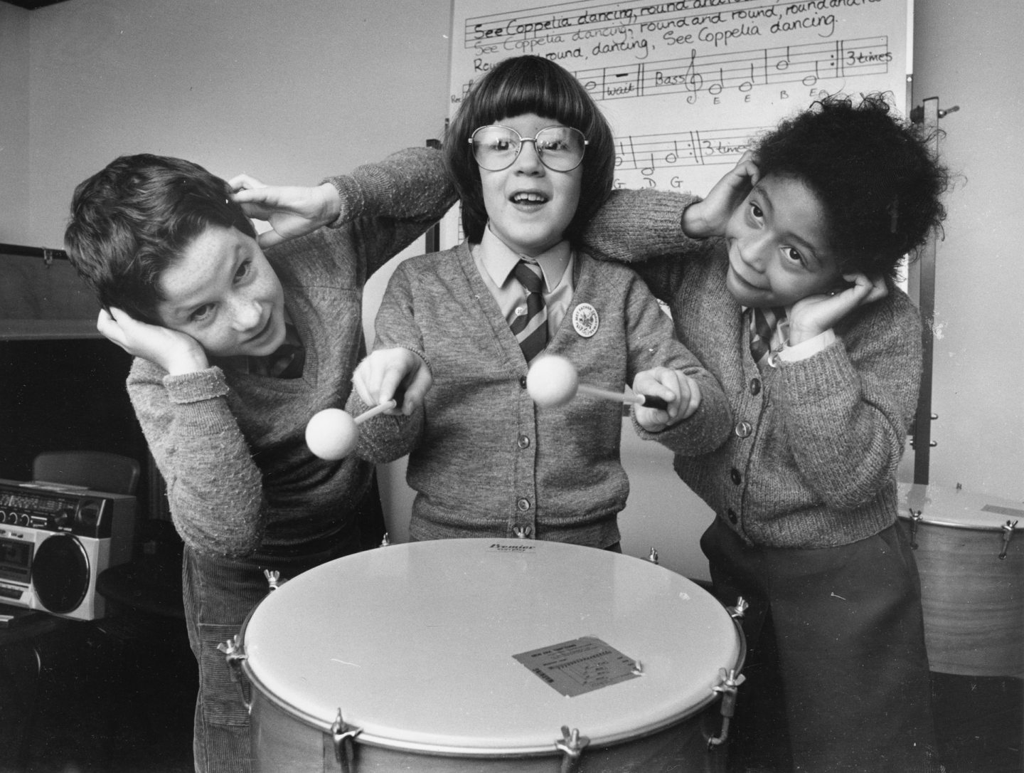 Classmates Lee Cruickshank and Emma Mitchell are deafened by Hannah Hesp's drumming during the primary 3/4 Christmas music rehearsals in 1987.