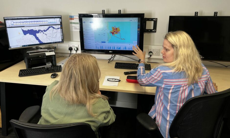 A Marine Scotland scientists explains how remote electric monitoring works during a visit to Peterhead by Environment Minister Gillian Martin.