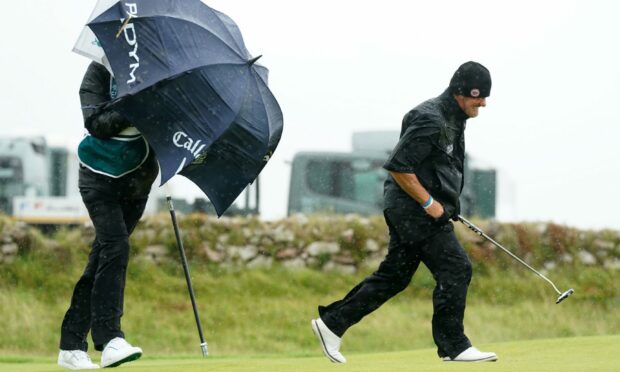 Alex Cejka (left) walks on the ninth fairway during day four of the  Senior Open at Royal Porthcawl. Image: PA.