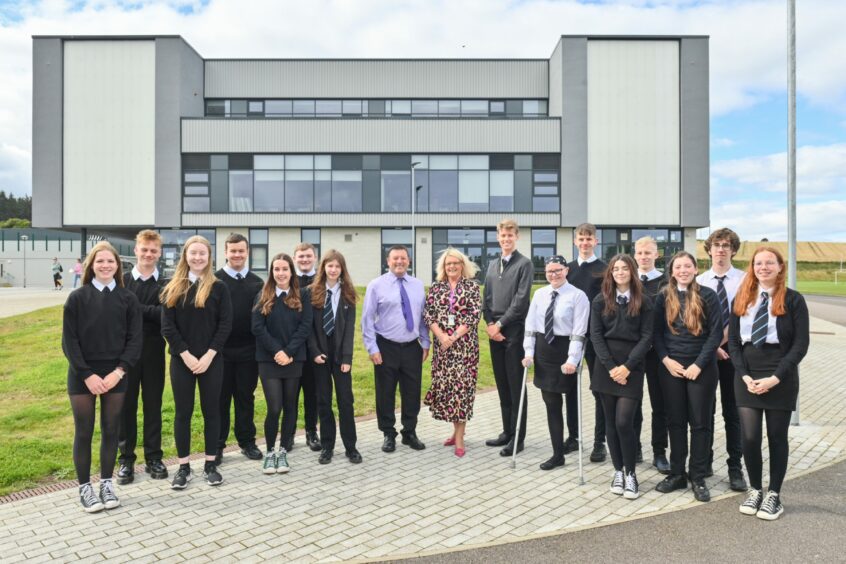  HOE Vivienne Cross and Head Teacher Hugh McCulloch are pictured with students from 4th, 5th and 6th year groups.