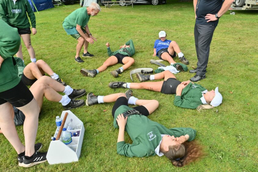 Members of the Cheadle team lying on the ground.